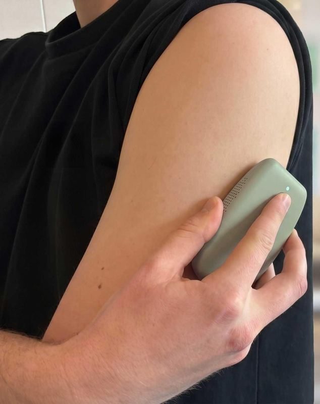 Loci scanner prototype held against an upper arm